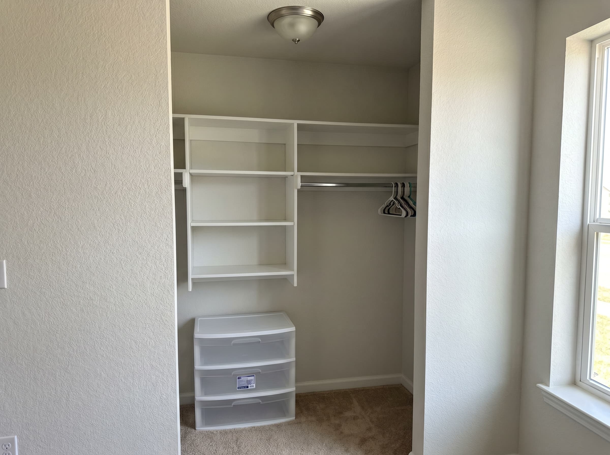 Buford, GA · Budget reach-in with white melamine shelves and drawer stack.
