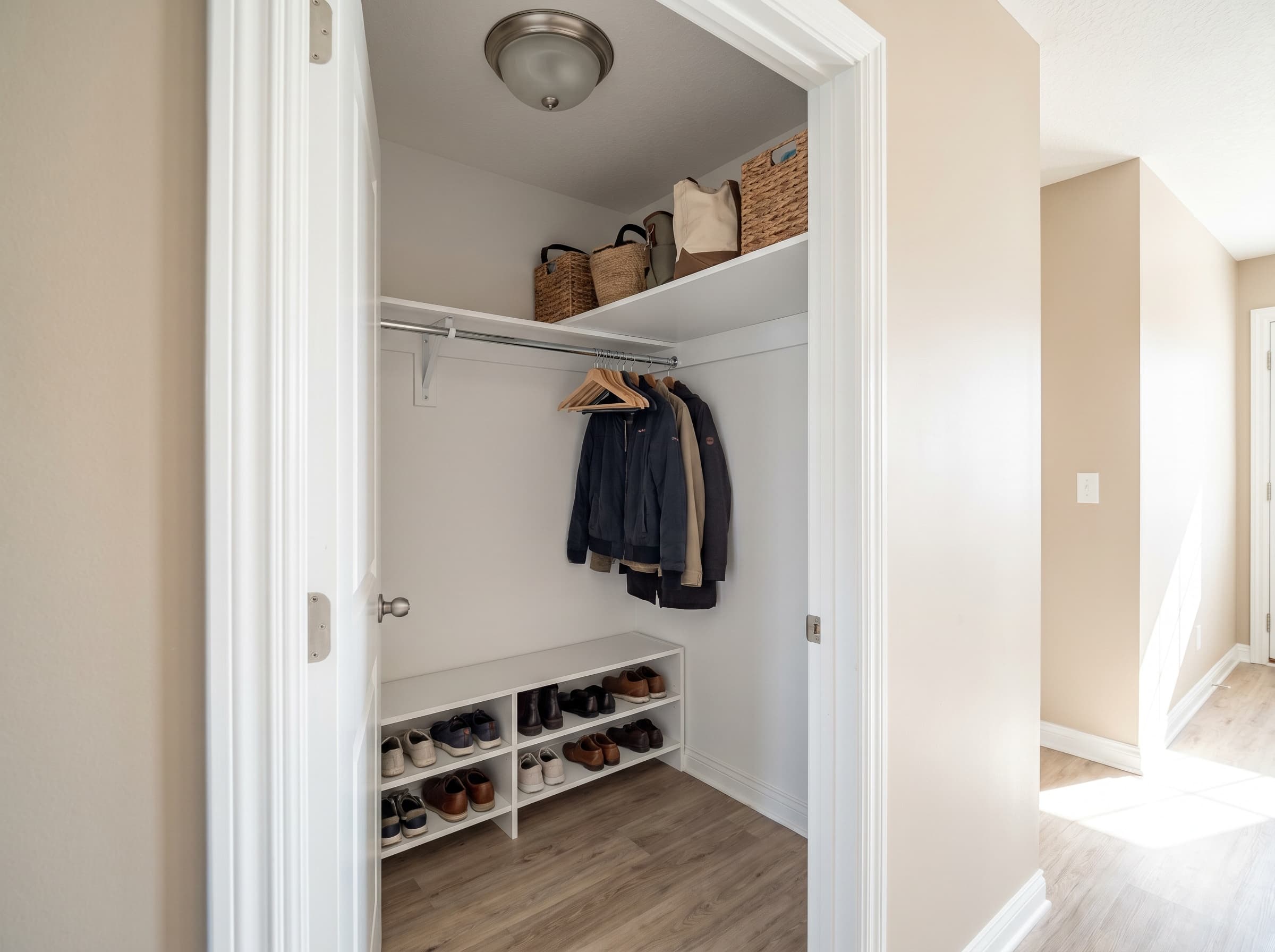 Dunwoody, GA · Front-entry coat closet with melamine rod and shoe shelves.