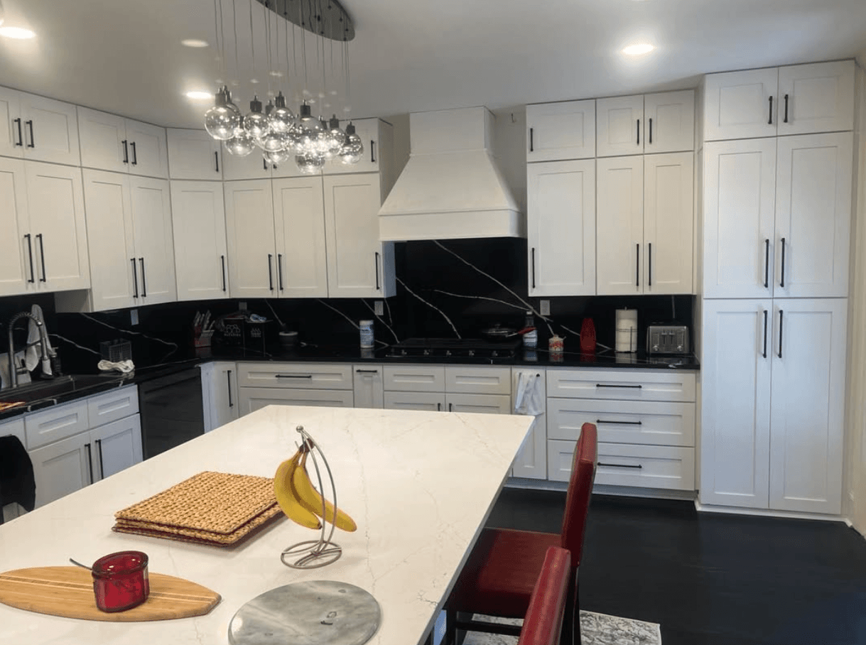 Dunwoody, GA · Tall white pantry tower with stained island and quartz top.