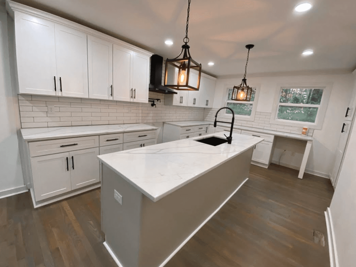 Powder Springs, GA · White shaker with island, brass pendants, and blue island accent.