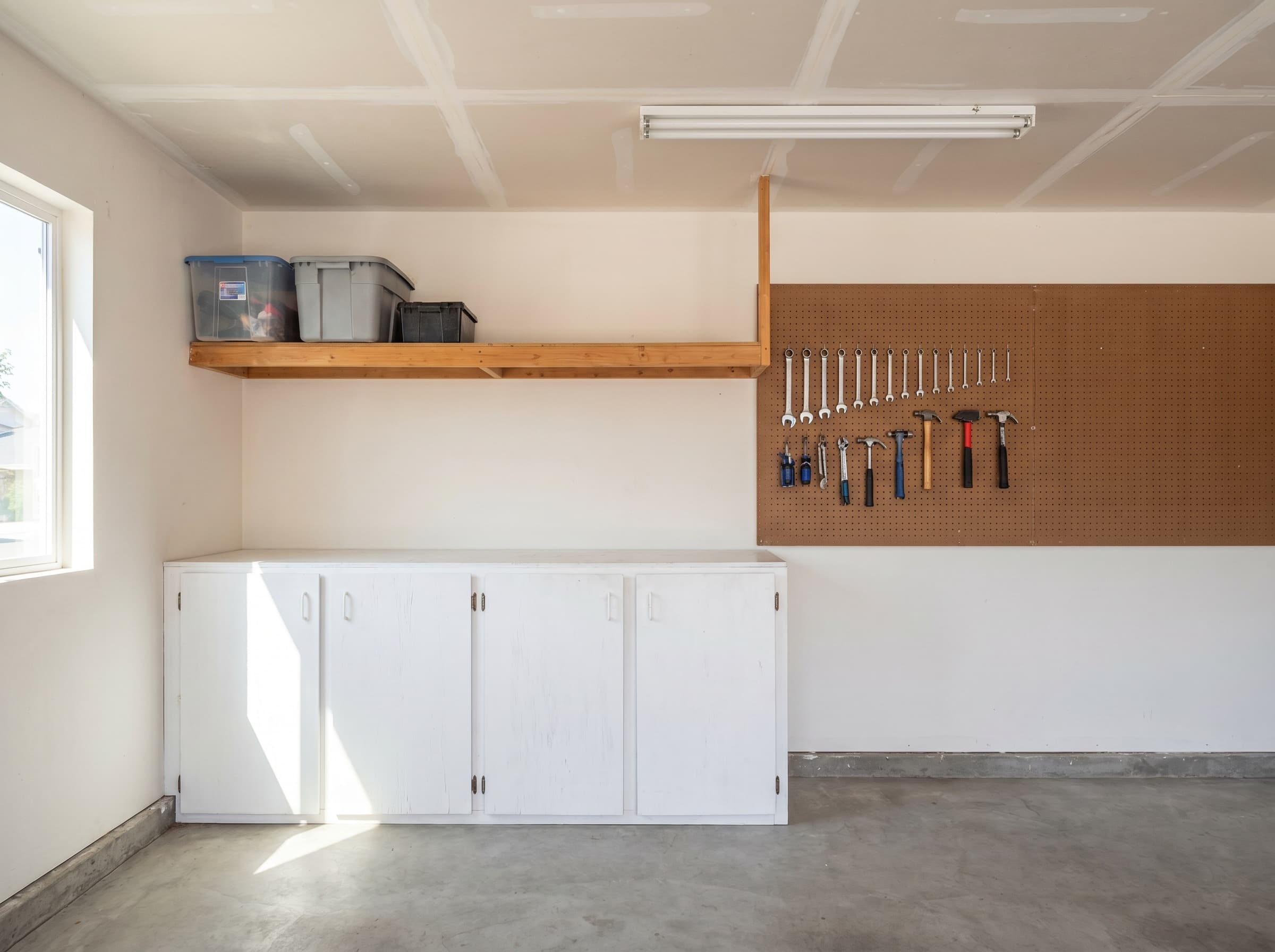 Smyrna, GA · 1-car garage with three plywood lowers, open shelf, simple pegboard.