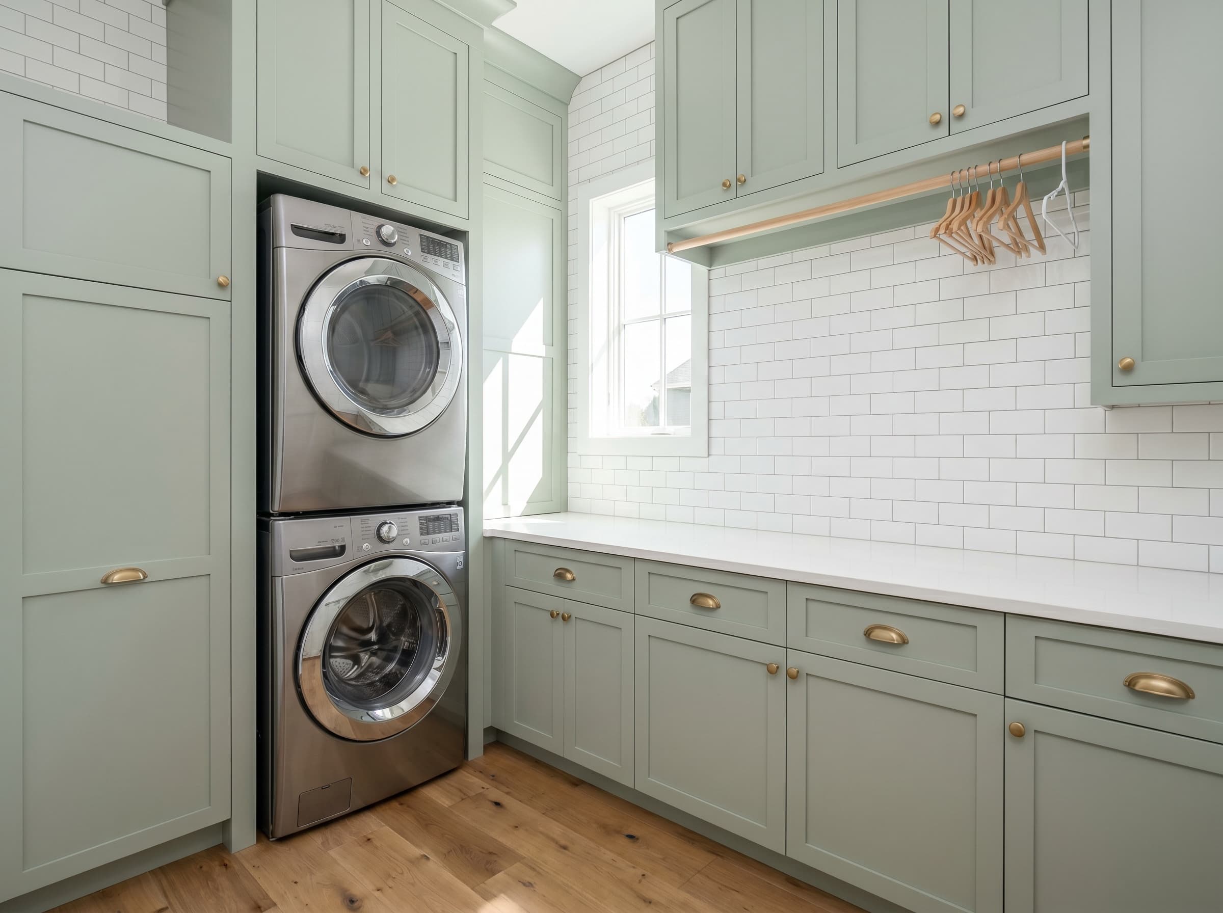 Lawrenceville, GA · Stacked stainless with soft sage shaker and brass pulls.
