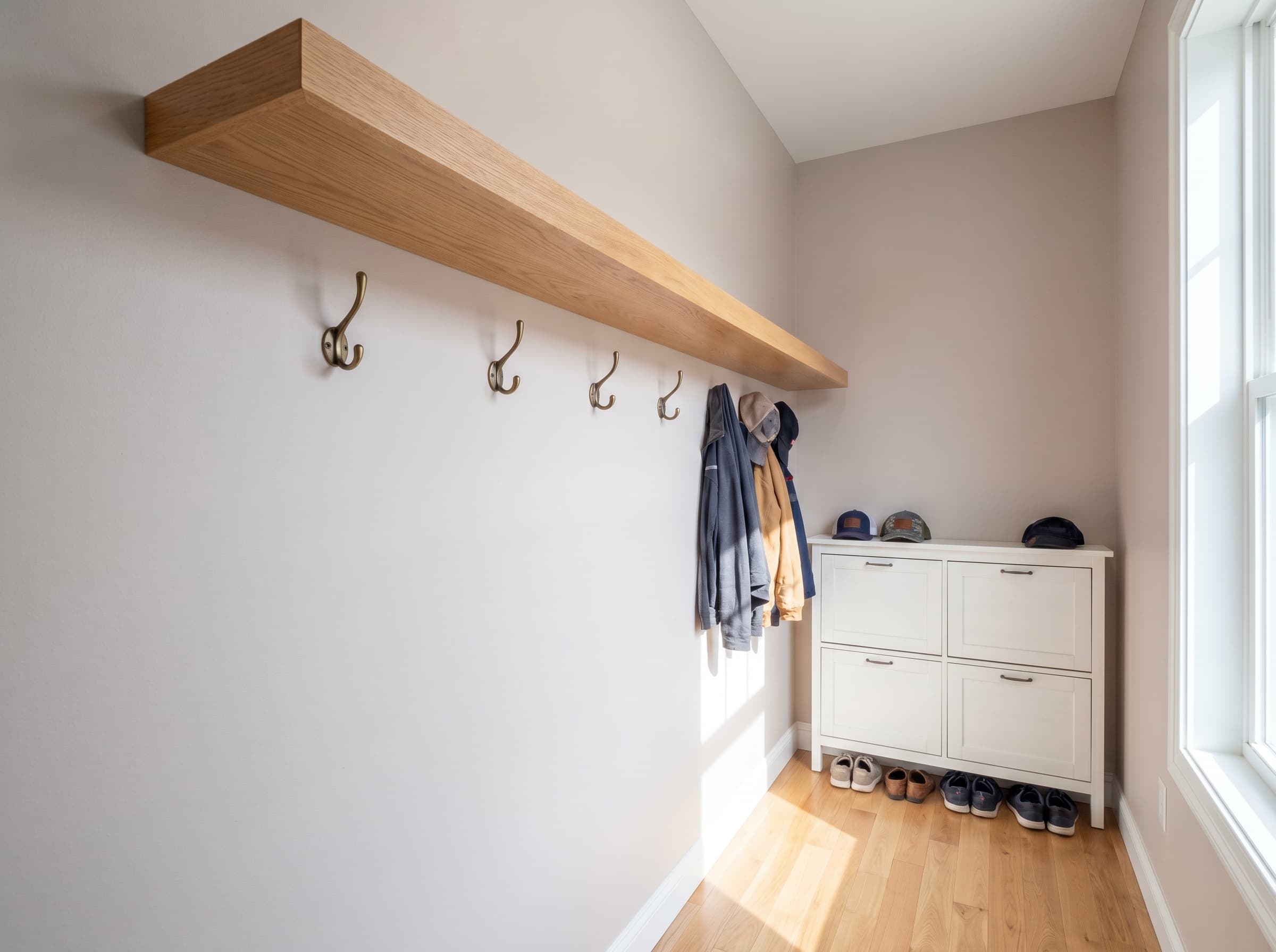 Cumming, GA · Tight hallway drop-zone with floating shelf, hooks, and shoe cabinet.