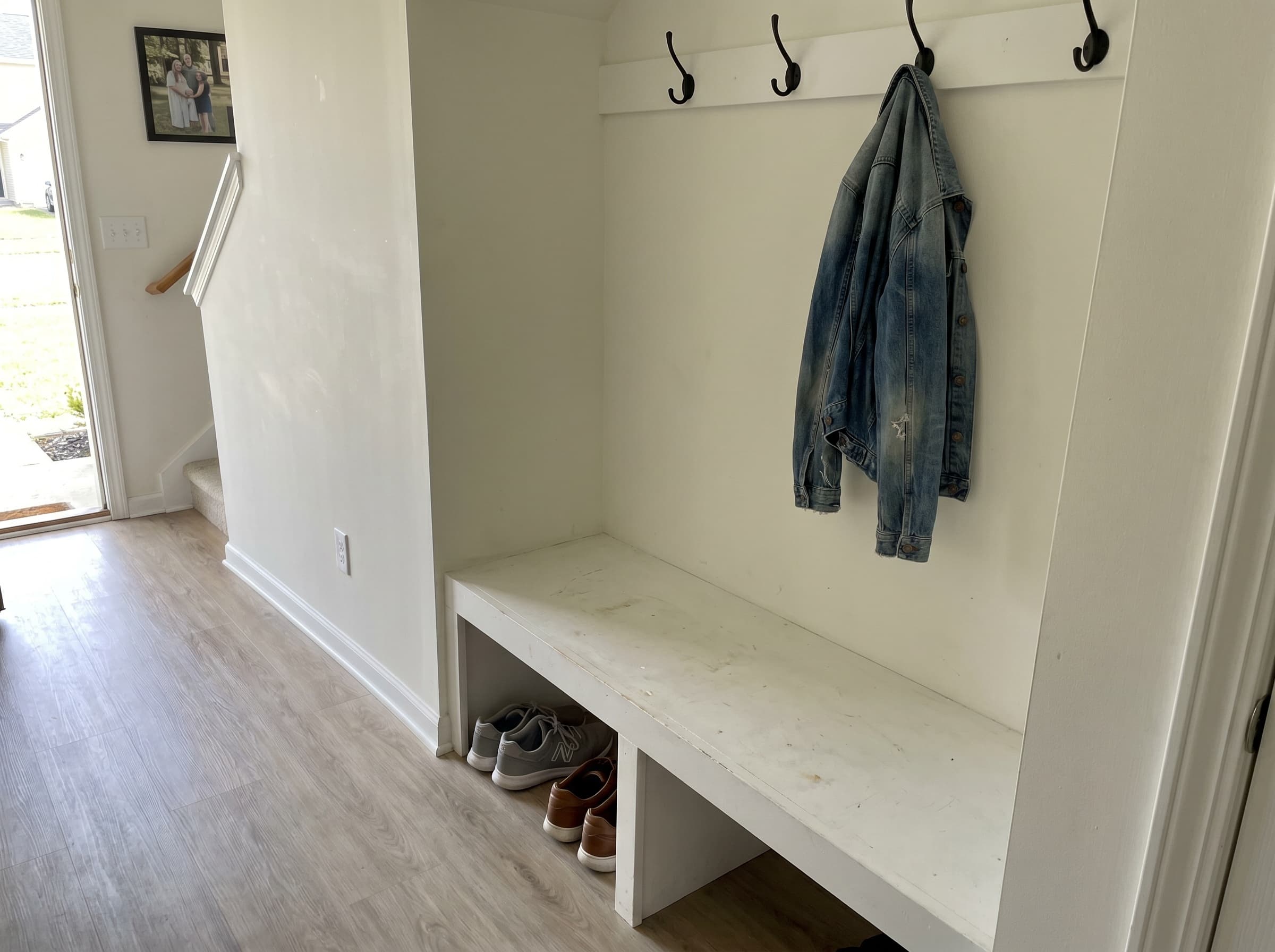 Smyrna, GA · Narrow hallway drop-zone with white-painted plywood bench.